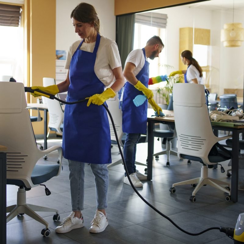 professional-cleaning-service-person-using-vacuum-cleaner-office